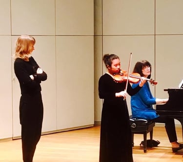 Violin teacher with her student practicing for a concert