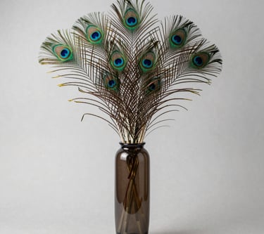 A sleek, modern vase with a smooth matte finish sitting on a wooden shelf against a soft neutral wall.