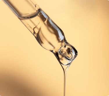a glass of water with a liquid pouring out of it