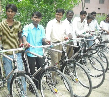 a group of men standing around a row of bicycles