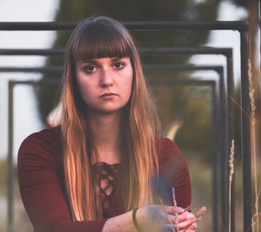 a woman in a red dress sitting under bicycle stands