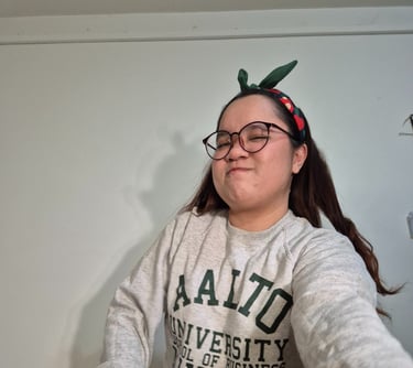 a woman in a grey Aalto university sweater