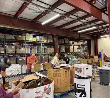 People working on a line at a food distribution center