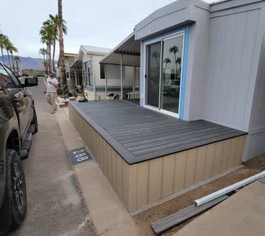 Best Handyman Tucson - A modern grey mobile home with a newly installed dark composite deck
