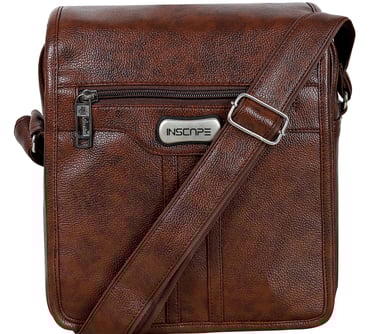 a brown leather sling bag with a silver metal buckle
