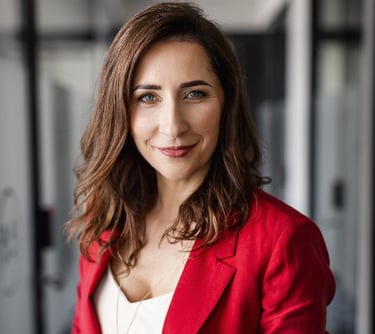 a woman in a red jacket and white top