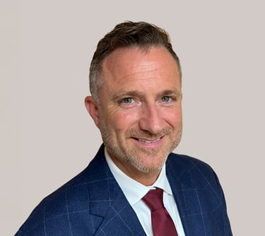 a man in a suit and tie smiling