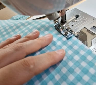a person sewinging a piece of cloth