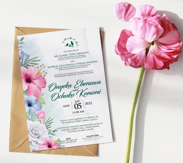 a wedding invitation card with a flower