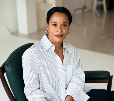 Edda Pay CCO Angel Marita Kirkegaard sitting in a chair with a black chair