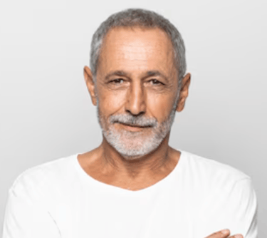 a man with a beard and a white shirt Martin PE / COACH