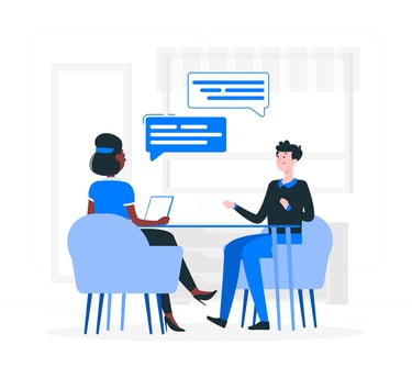 a man and woman sitting at a table with a laptop doing 1-1 consultation for resume writing