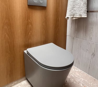 grey toilet and oak paneling