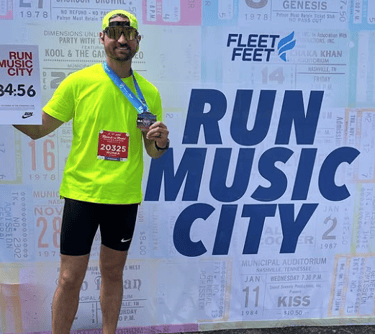 a photo of the owner of Race Ready events standing in front of a wall for the Nashville Marathon