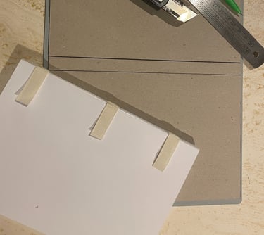 a handbound notebook in the creation process with tools required for book binding