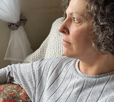 the founder of Foto Furnished Emma looking ahead, resting on one of her own handmade poppy cushions