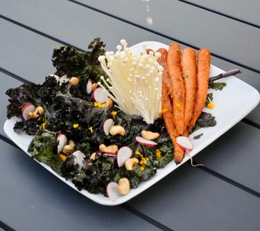 a person squeezing lemonade on a plate of food