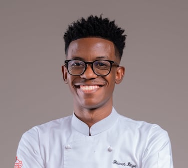 a man in a chef's uniform and glasses