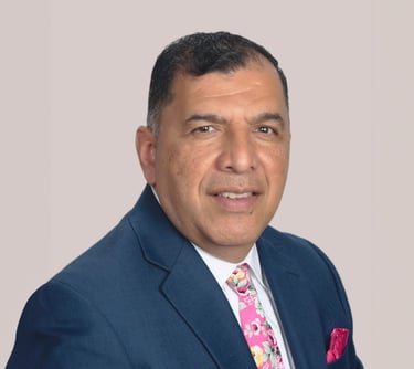 a man in a suit and tie with a pink tie