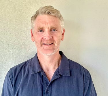 a man with a beard and a blue shirt