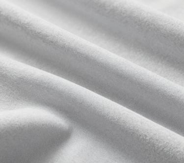 Close-up of Bamboo Cotton fabric, showing its soft, eco-friendly texture. Neutral lighting, emphasizing the organic quality and light grey/white tones of the #F0F4F8 palette.