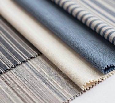Elegant swatches of Yarn-Dyed Striped viscose fabrics. The composition is clean and organized, showcasing the variety of colors and precision of the stripe patterns.
