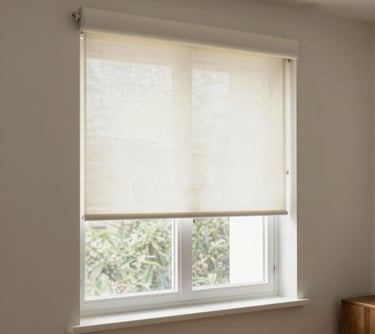 Close-up of elegant roller shades softly filtering sunlight in a modern living room.