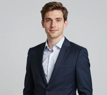 Portrait of a young, professional entrepreneur (Attmann Stefanou) in a modern navy suit, looking confident and approachable, clean studio lighting with a neutral background.