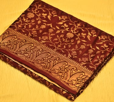 Luxurious maroon Banarasi silk saree adorned with intricate gold zari work, ideal for grand occasion