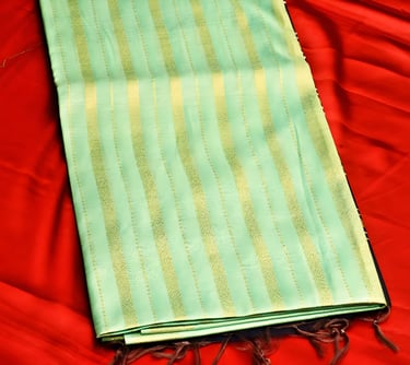 Elegant green Chanderi silk saree with golden stripes, perfect for festive and wedding occasions.