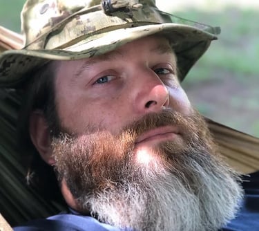 a man with a hat on a hammock