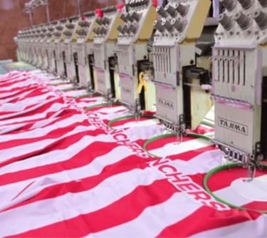 a row of sewing machine with a red and white striped shirt