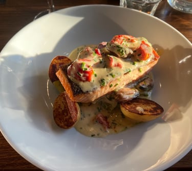 a plate of food with potatoes and salmon on it