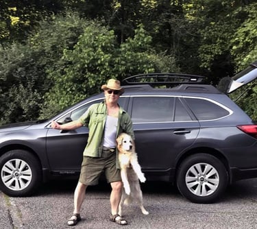 The author with his dog, Vinnie, in front of his Subaru Outback