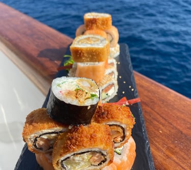 Sushi plated in rock dish with sea as background