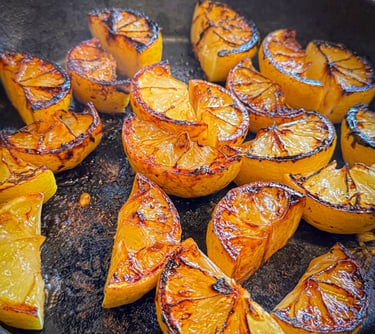 Lemon wedges grilled in a cast iron skillet