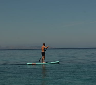  Person paddleboarding on calm waters off the coast of Alcudia