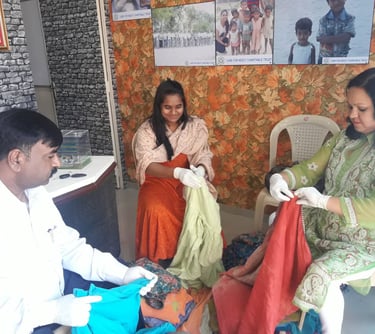 Two women and a man sitting doing activity
