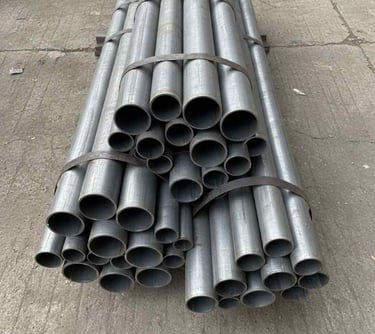 Top view of assorted round steel pipes arranged for catalog display.