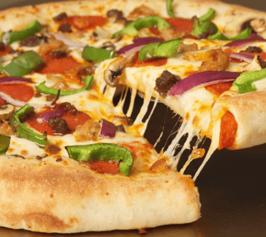 A picture of a big pizza with bell peppers, onions, pepperoni, and cheese.