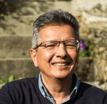 a man with glasses and a sweater sweater