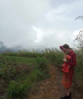 a man in a field with fog and overcast conditions deep in thought
