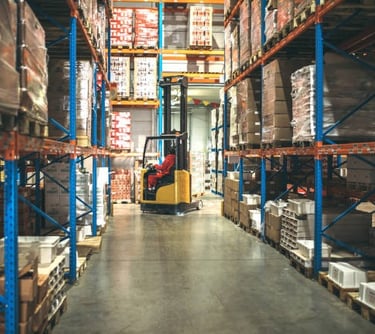 Forklift operator inspecting racking