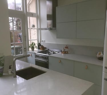 a kitchen with a sink, stove, and refrigerator