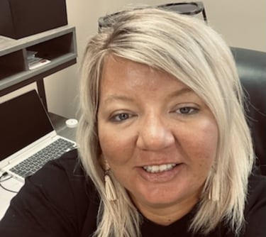 a woman in a black shirt and a laptop
