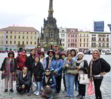 a group of people standing in front of a clock tower