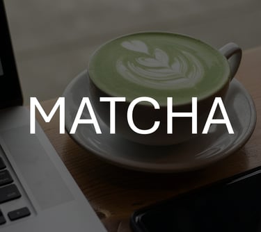 Photo of cup of matcha latte, darkened to contrast against white text overlay that says 'MATCHA'