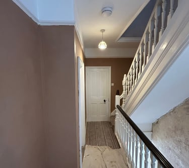 Renovation of the hallway of a house with plastered walls.