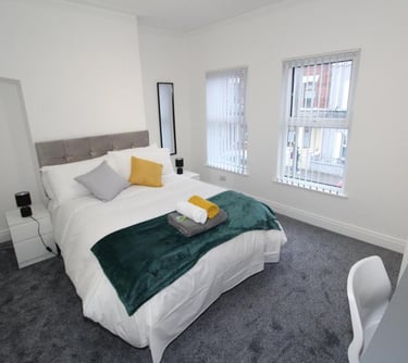 bedroom with bed and white walls