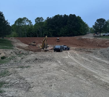 digging a big pond, large excavator and dozer digging a pond